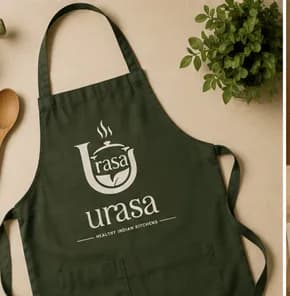 Urasa apron laid flat beside kitchen tools